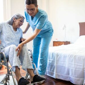 geriatric-nursing-assistant-helping-senior-get-out-of-wheelchair geriatric-nursing-assistant-helping-senior-get-out-of-wheelchair